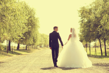 Bride and groom walking and holding hands