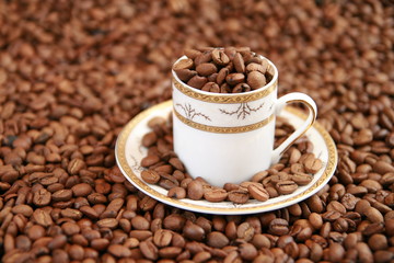 Coffee cup full of coffee beans
