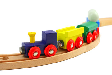 Wooden train toy on rails isolated on white