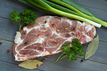 Fresh raw pork shoulder chop with spices