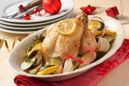 Roasted whole chicken with vegetables and christmas decoration