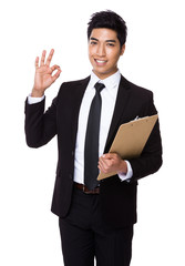 Businessman with clipboard and ok sign