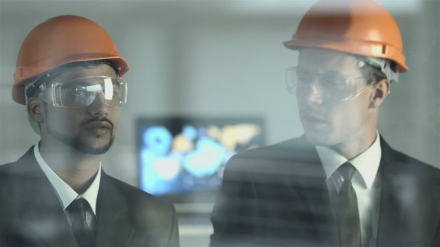 The builders discuss the information at the virtual screen