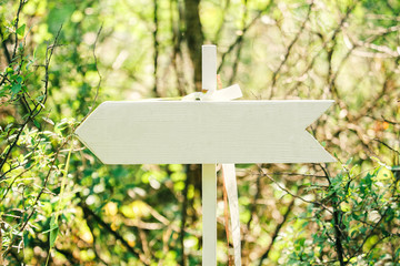 White wedding wooden arrow sign with ribbons