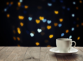 Cup of hot drink on bright background