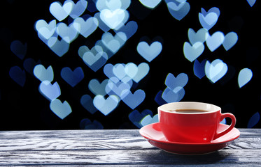 Cup of hot drink on bright background