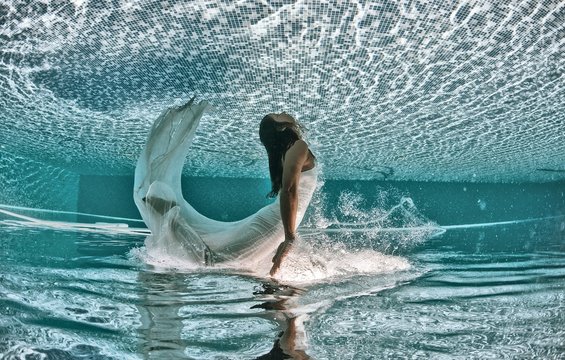 Beautiful woman underwater swiming