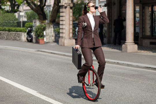 portrait of businesswoman with unicycle