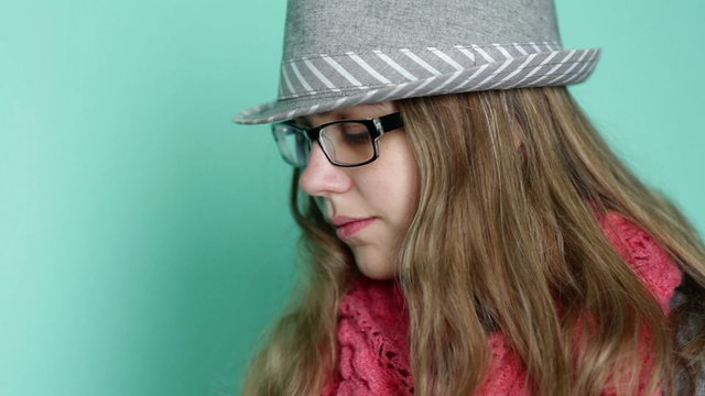 beautiful girl with glasses wearing a hat on a background of tur