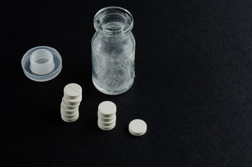 medicine, white tablet, black background