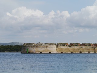 Fototapeta na wymiar A fortress in the mouth of the Krka near Sibenik