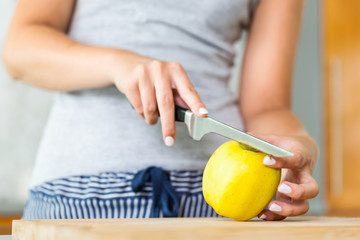 Close up of woman slicing apple