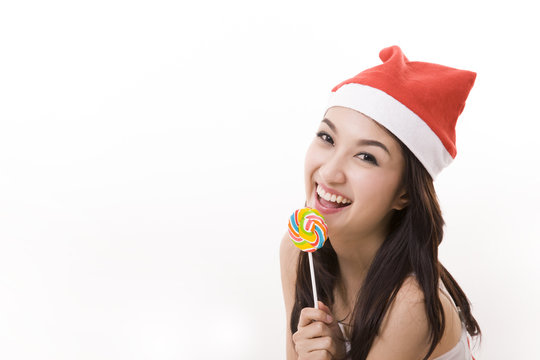 happy smile girl wearing a santa suit holding a candy for christ