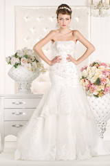 Fototapeta na wymiar Gorgeous bride with white dress with flowers bouquet