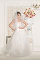 Gorgeous bride with white dress with flowers bouquet