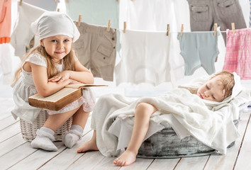 Two small children in the laundry