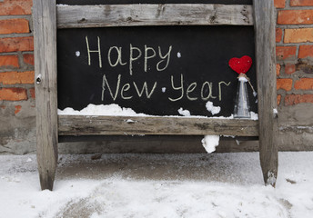 grunge chalk inscription on the board happy new year