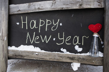 grunge chalk inscription on the board happy new year