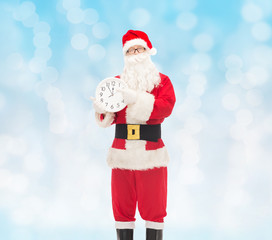 man in costume of santa claus with clock