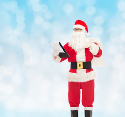 man in costume of santa claus with notepad and bag