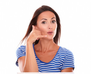 Cute female gesturing a phone call