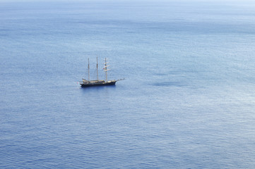 Sailboat sailing with sails furled