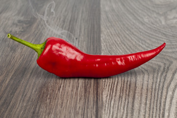 Red hot chili peppers on old wooden table