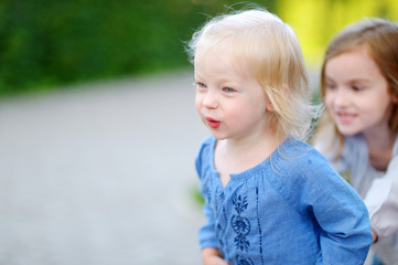 Two little sisters having fun on a summer day