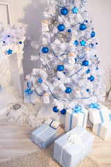 Christmas tree, fireplace, watches, toys, gifts in a white room