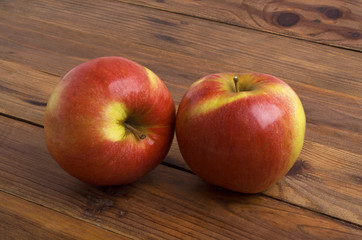 Red apples on rustic wooden background