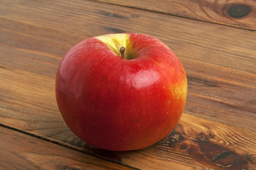 Red apple on rustic wooden background