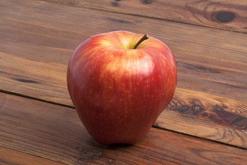 Red apple on rustic wooden background