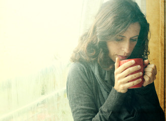 Beautiful young woman enjoing cup of coffee. Retro vintage insta