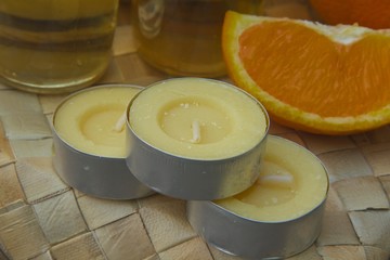 Three candles with orange fragrance