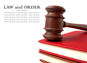 Wooden gavel and books on a white background