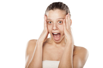 surprised young woman covering her head with her hands