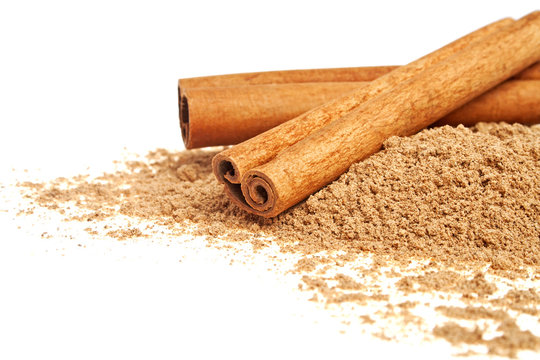 Cinnamon sticks and powder on a white background