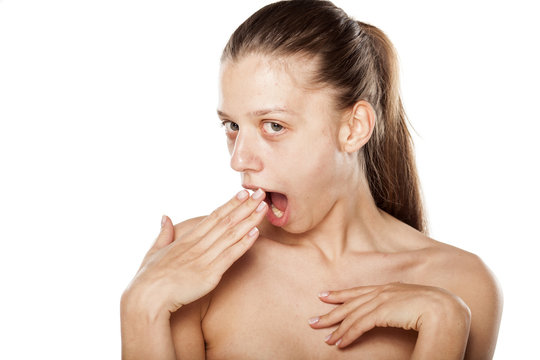 surprised young woman covering her mouth with hand