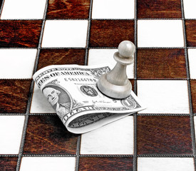 Pawn with dollar on the chess board