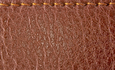 Brown leather label with seam, abstract background