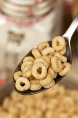 A spoon of corn flakes rings. Macro. Selective focus.