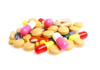 Colored pills and tablets on a white background