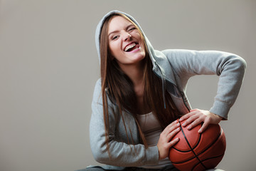  Funny sporty girl holding basketball winking