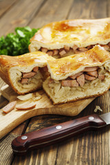 Pie with cabbage and sausages