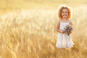 Little girl with a bouquet of wild flowers