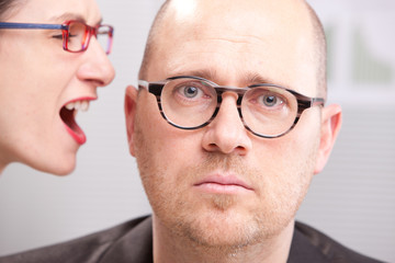 woman shouting in man's ear