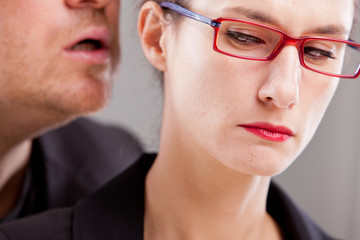 man hissing menaces in woman's ear