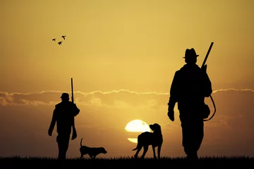 Fototapeten Jäger bei Sonnenuntergang © adrenalinapura