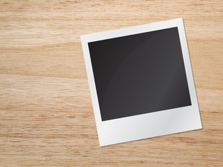 Old blank photograph on wooden table
