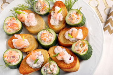 Fresh snack with salmon and shrimp on a plate